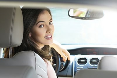 a woman sitting on the seat of a car